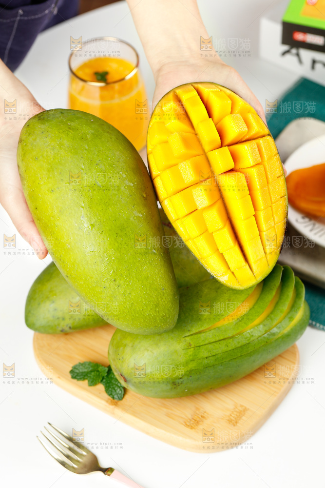 手上拿着芒果