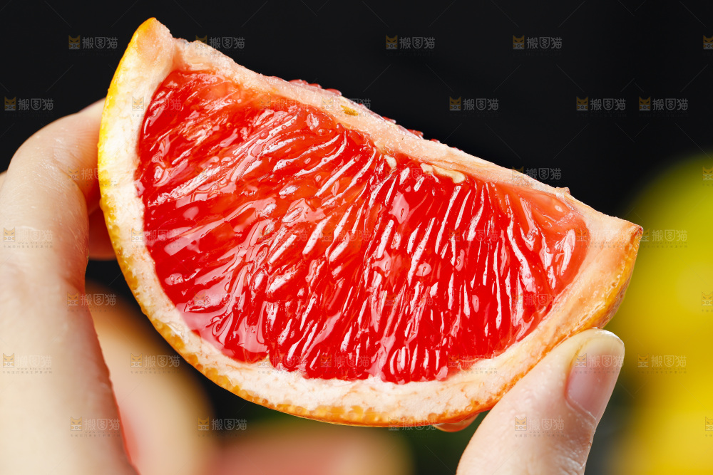 手拿切开的红心西柚