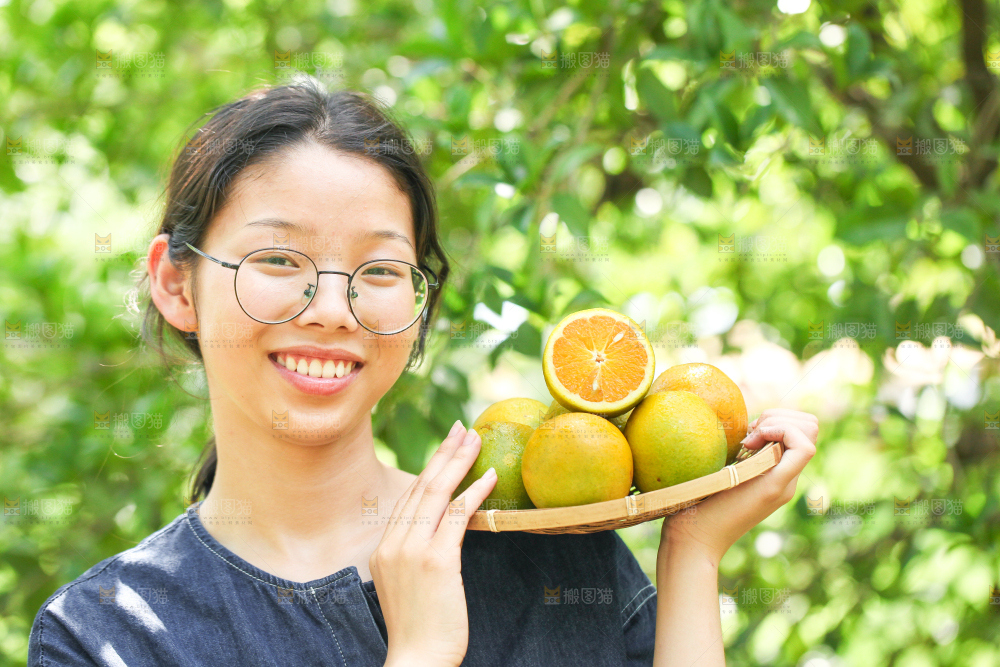手里拿着一篮夏橙