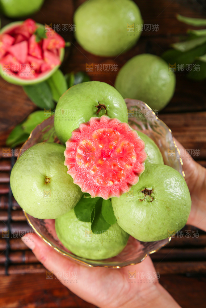手里端着一碟红芭乐