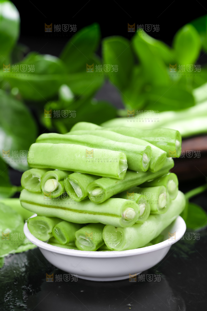 一碗新鲜四季豆放在黑底上