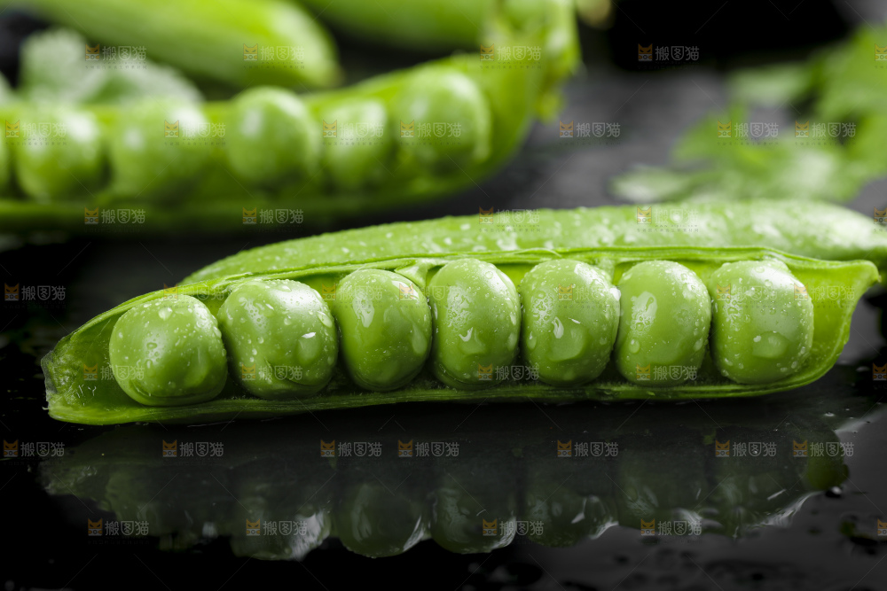 黑石板上堆放着甜豌豆