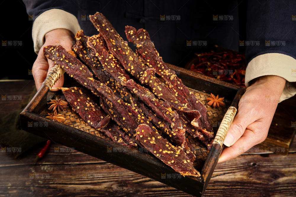 手里端着一盘牛肉干