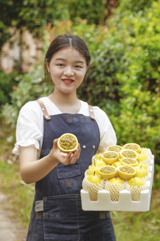 女孩手上端着一箱黄金百香果
