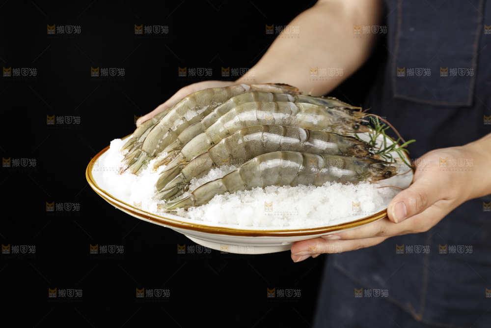 手上端着一盘大虾
