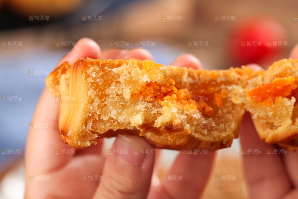 手拿着掰开的蛋黄月饼