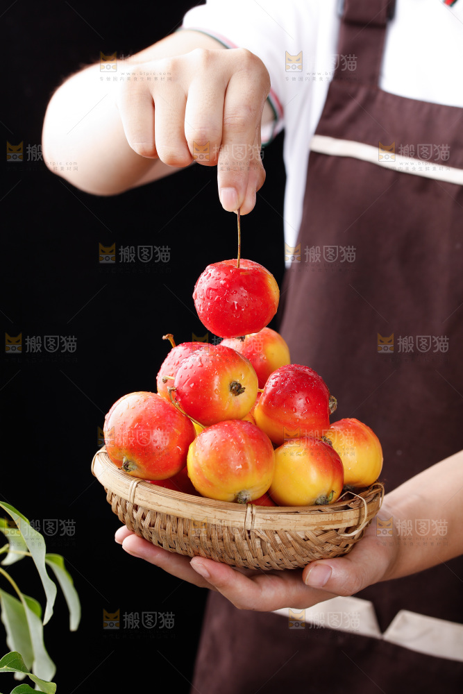 手拿着一筐新鲜海棠果