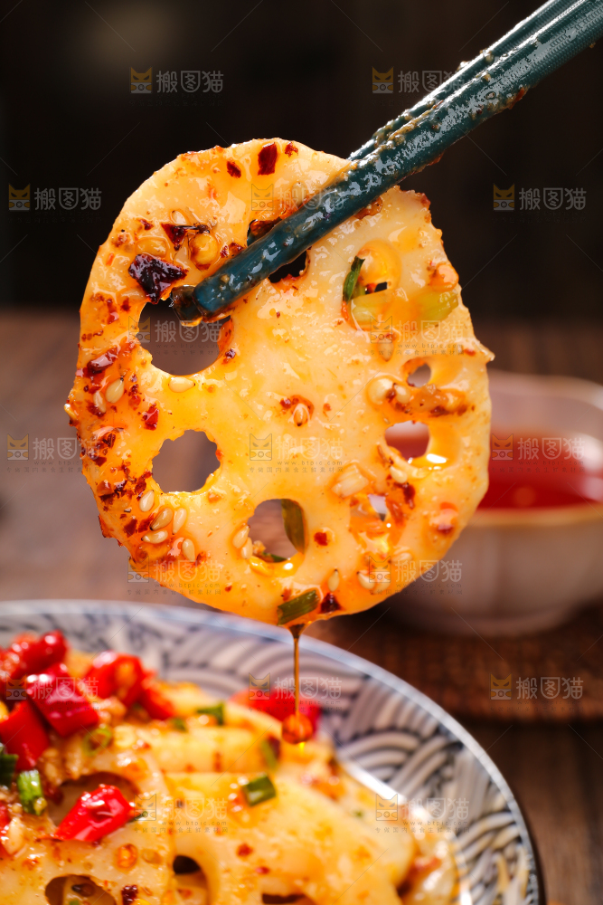 筷子夹着麻辣藕片