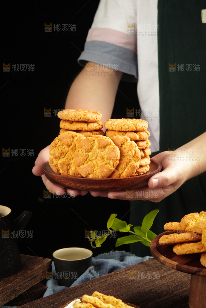 手里端着一盘传统桃酥