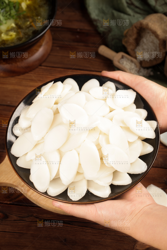 手里端着一盘宁波年糕片