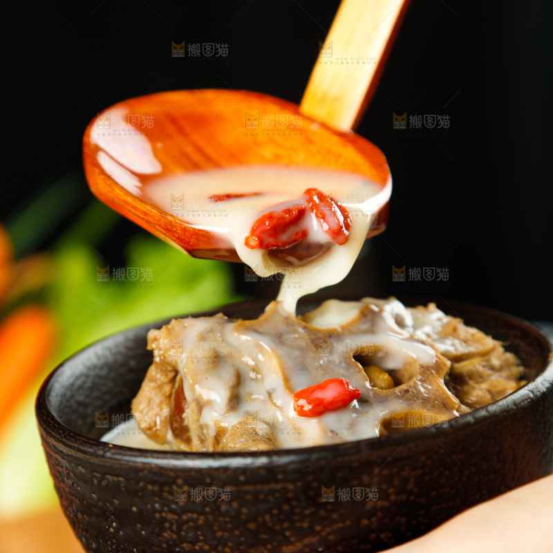 手里端着一碗羊蝎子汤