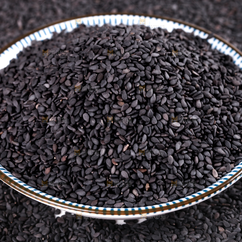一碟黑芝麻放在白底上