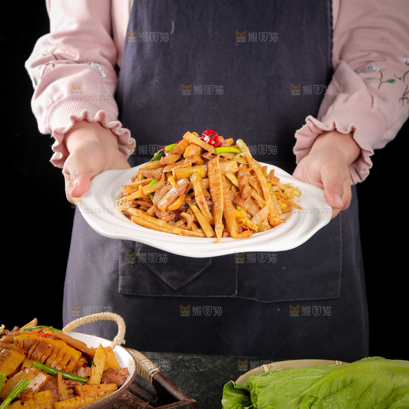 手里端着一盘竹笋烧肉