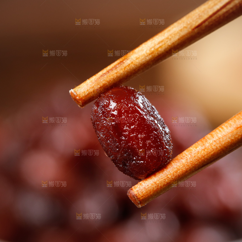 筷子上夹着糖蜜红豆