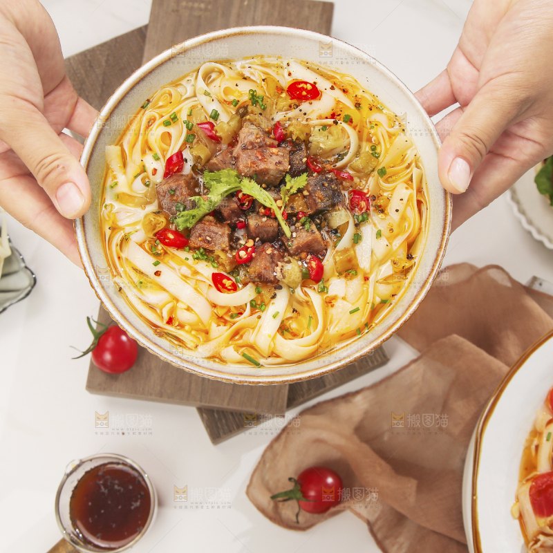 手上端着一碗牛肉拉面