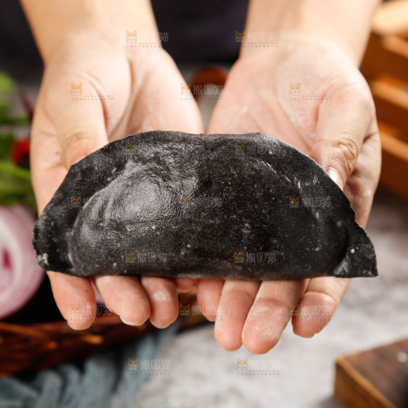 手上放着墨鱼大饺子