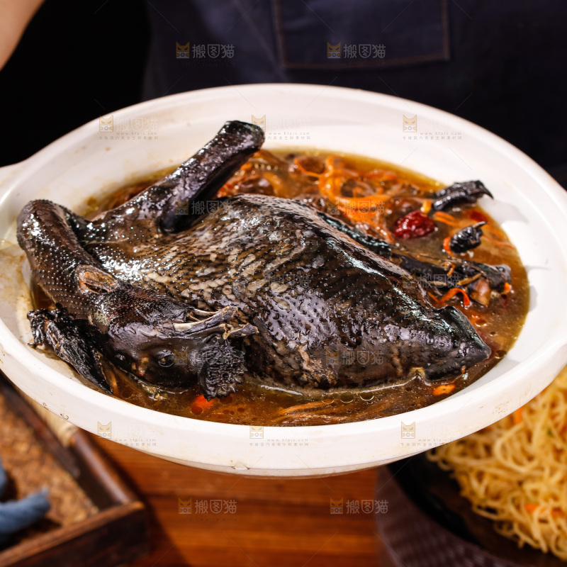 手里端着一锅茶树菇乌鸡汤